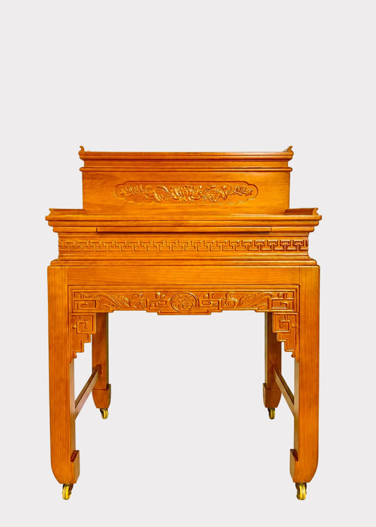 A traditional Chinese wooden lectern or altar stand with ornate relief carvings and brass caster wheels, shown against a plain light gray background.