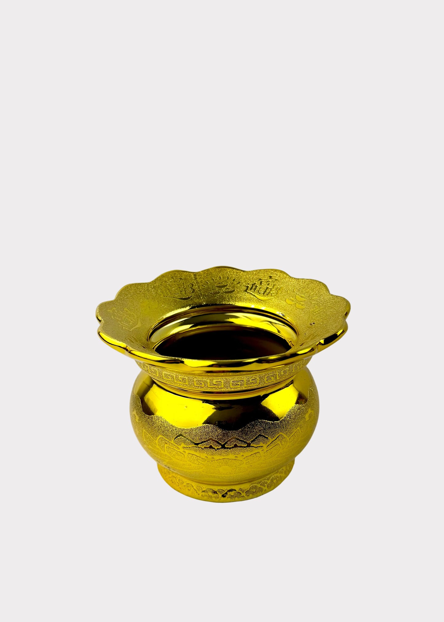 A shiny gold metal flower-shaped cup or incense holder with a scalloped rim and a rounded base, shown on a plain light background.