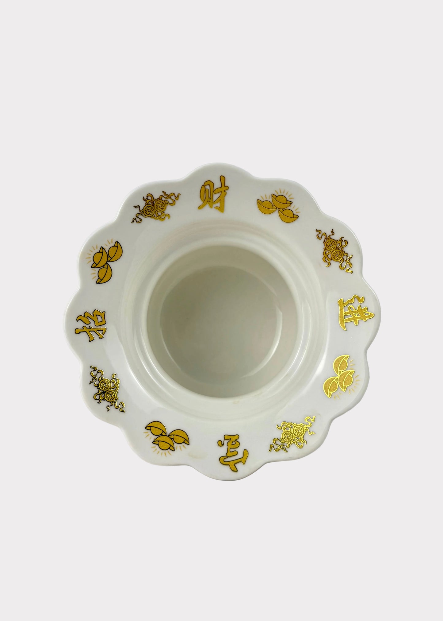 A white ceramic bowl with a scalloped rim, decorated with gold Chinese characters and floral motifs, set against a plain white background.