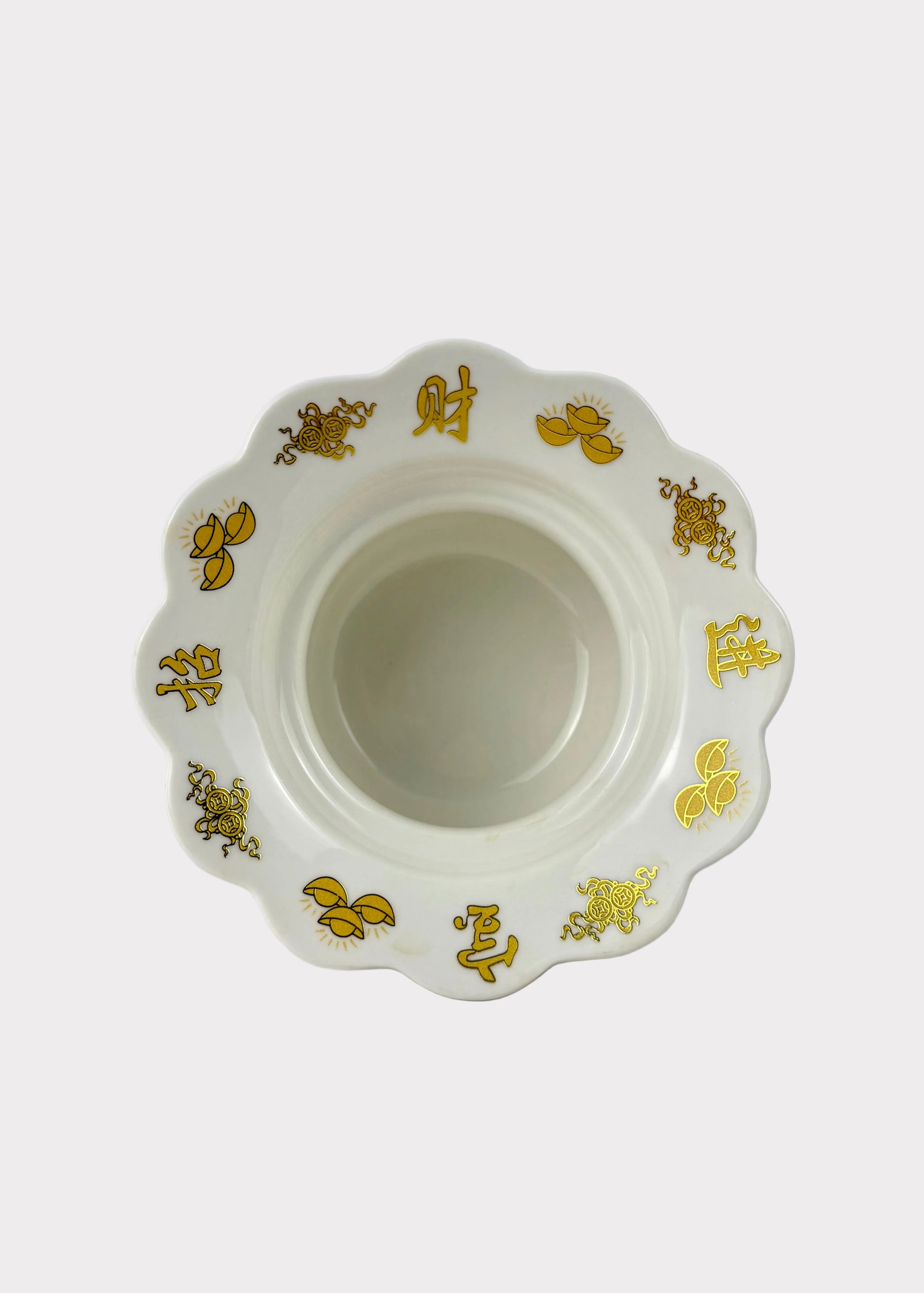 A white ceramic bowl with a scalloped rim, decorated with gold Chinese characters and floral motifs, set against a plain white background.