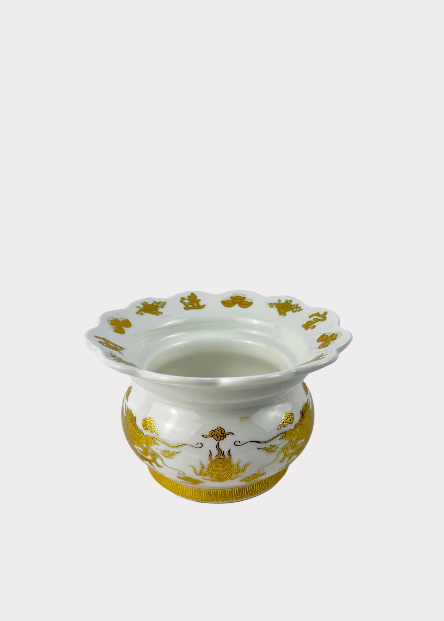 A white ceramic vase with a fluted rim and gold decorative patterns, set against a plain light gray background.