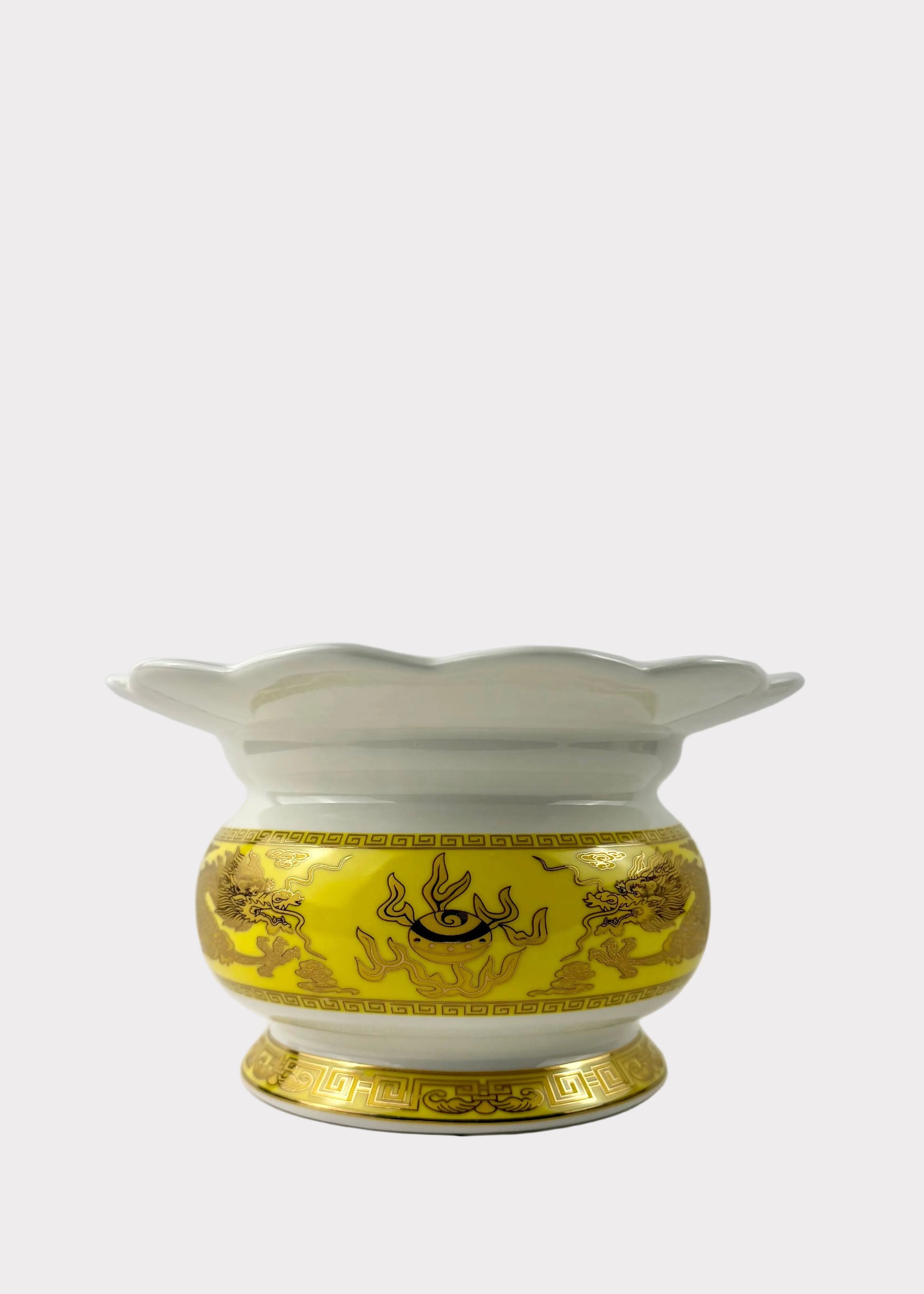 A white porcelain incense burner with a yellow and gold dragon-patterned band around the middle, set against a plain light gray background.