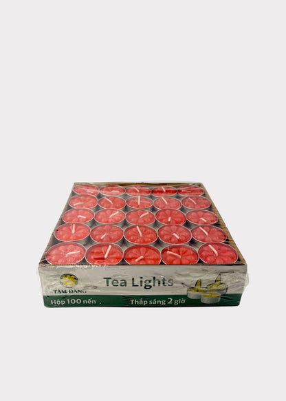 A box of red tea lights wrapped in clear plastic, placed on a white surface against a white background. The box has Vietnamese text and a small logo on the front.