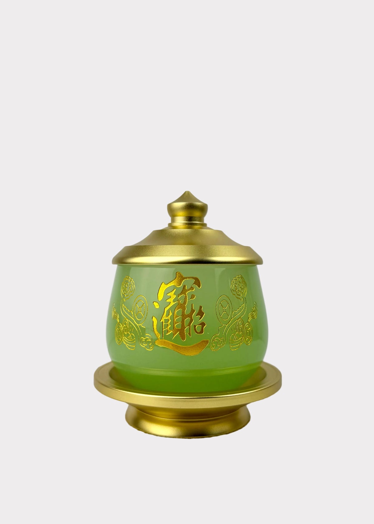 A green glass jar with a gold lid and base, decorated with gold Chinese characters and floral patterns, set against a neutral gray background.