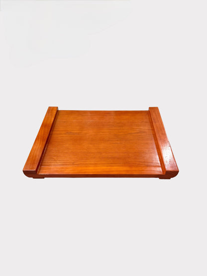 A rectangular wooden serving tray with raised sides, made of reddish-brown wood with a glossy finish, shown against a light gray background.
