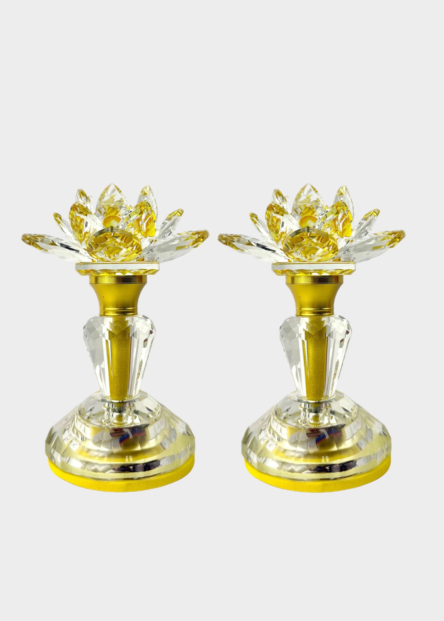 Two gold and clear crystal light with lotus-shaped flower tops, shown side by side on a light gray background.