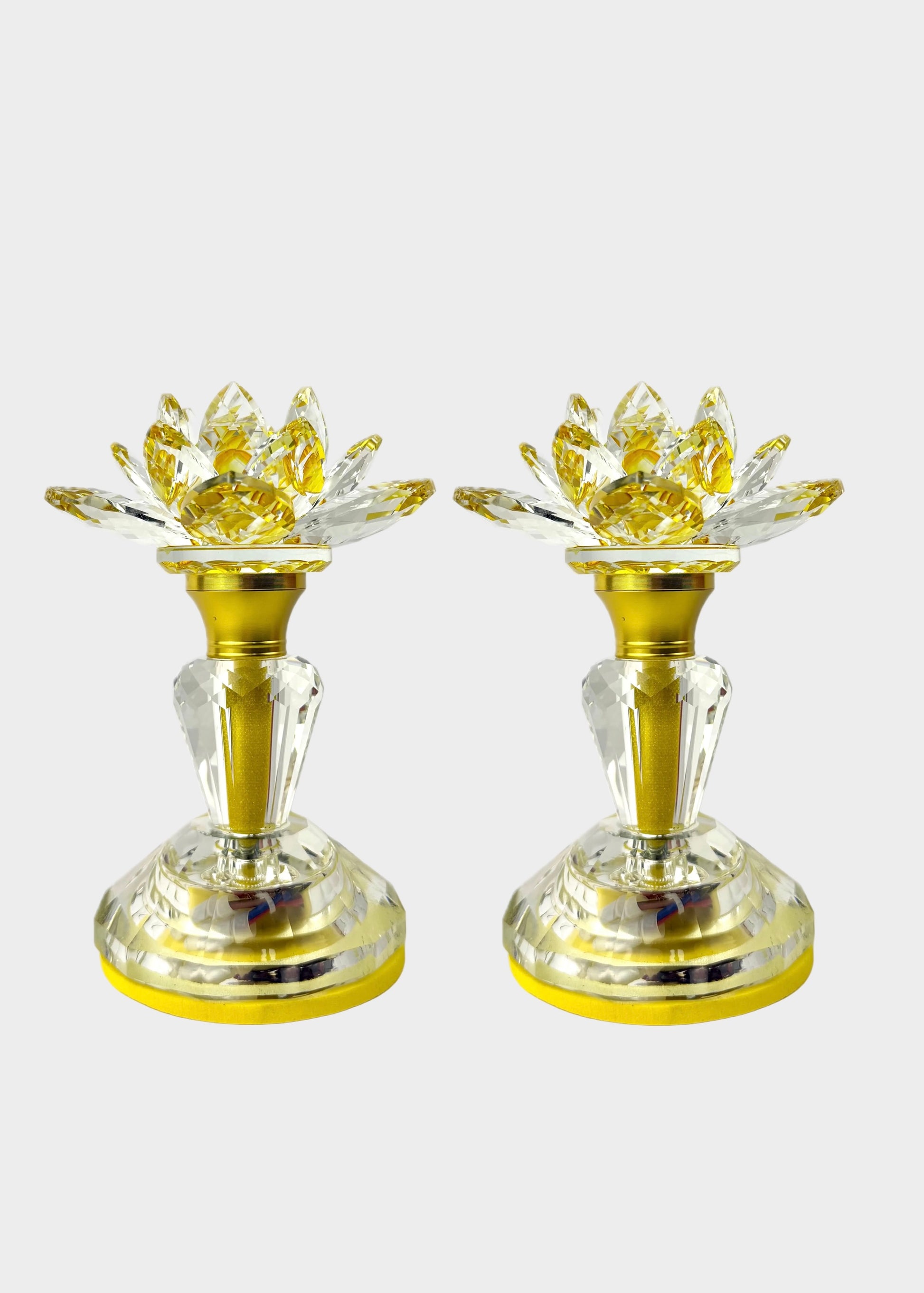 Two gold and clear crystal light with lotus-shaped flower tops, shown side by side on a light gray background.
