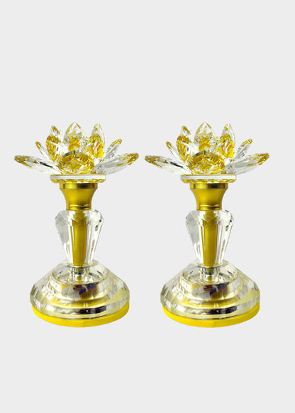 Two gold and clear crystal light with lotus-shaped flower tops, shown side by side on a light gray background.