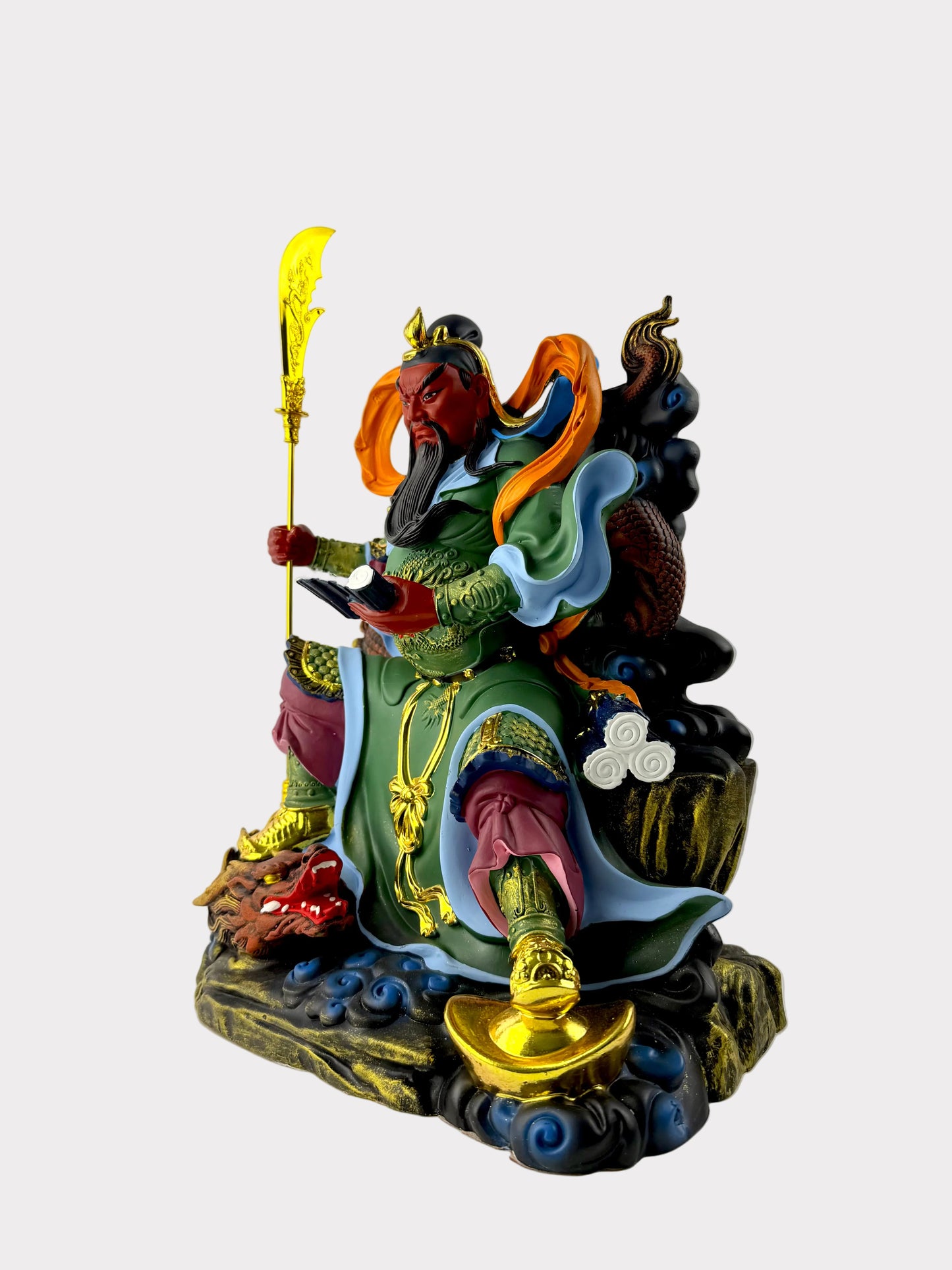 A colorful Chinese deity statue depicting a warrior seated on a cloud base, holding a golden staff, with green, blue, red, orange, and gold details.