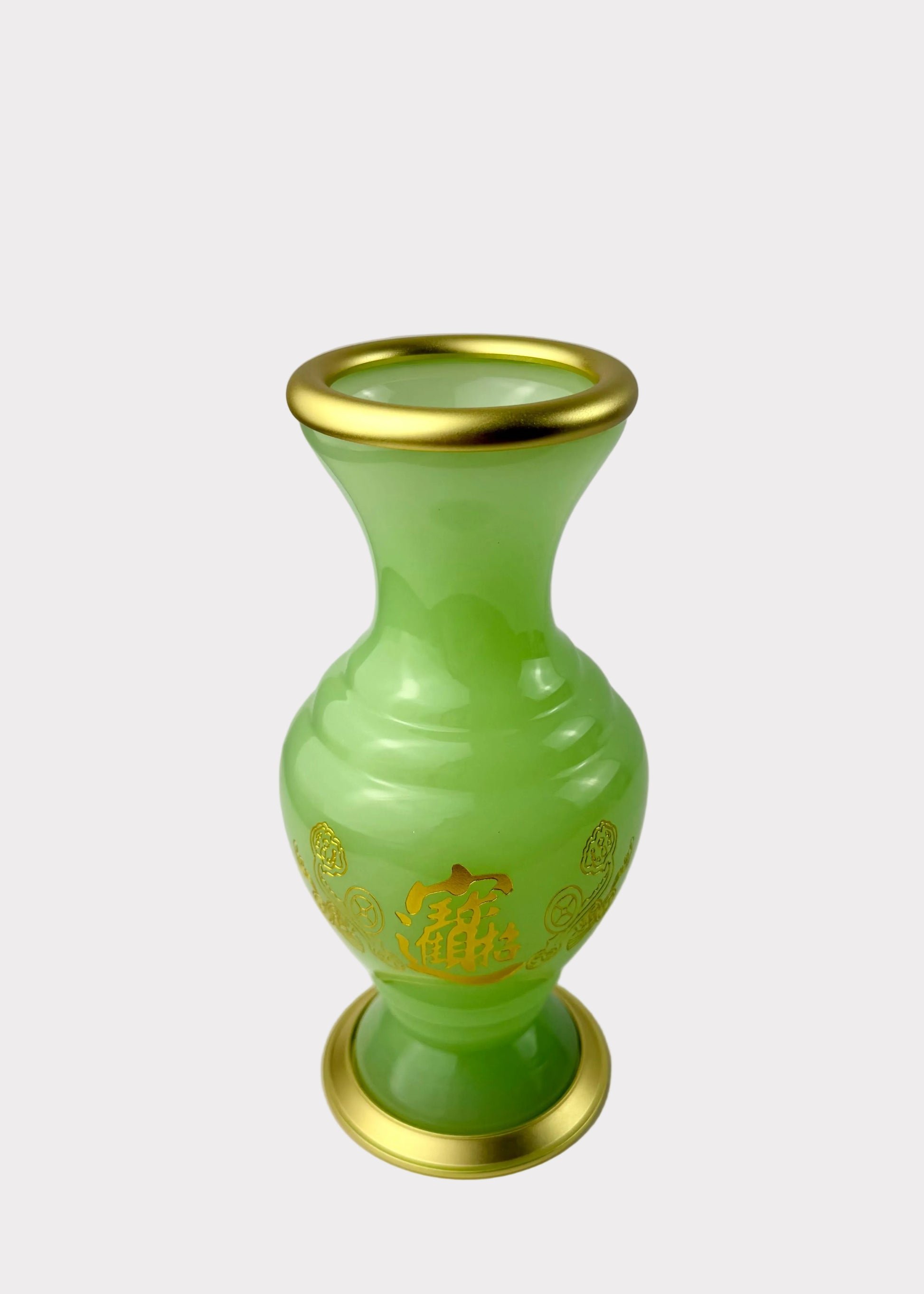 A light green glass vase with gold trim on the rim, base, and decorative gold characters on the front, set against a plain white background.