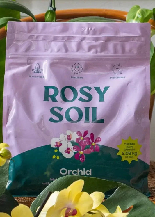 Rosy Soil packaging with orchids in the background