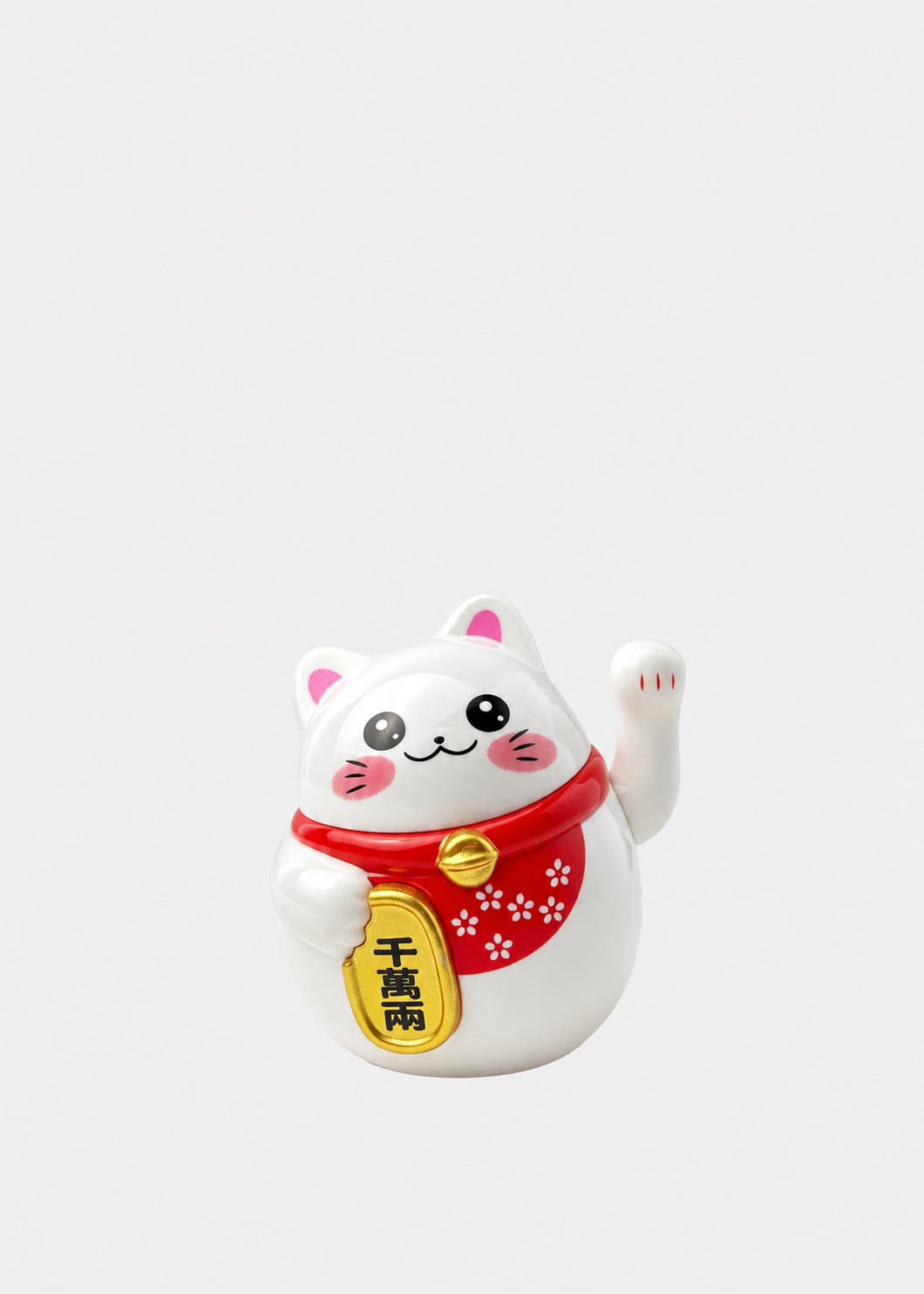 A white Japanese maneki-neko lucky cat figurine with a raised paw, wearing a red collar with a gold bell and a gold hanging tag, set against a plain light gray background.