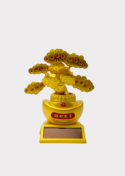 A golden bonsai-style tree figurine with red and gold circular details, mounted on a gold ingot-shaped pot and rectangular base, photographed against a plain white background.
