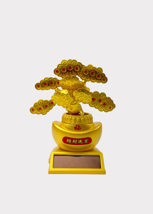 A golden bonsai-style tree figurine with red and gold circular details, mounted on a gold ingot-shaped pot and rectangular base, photographed against a plain white background.