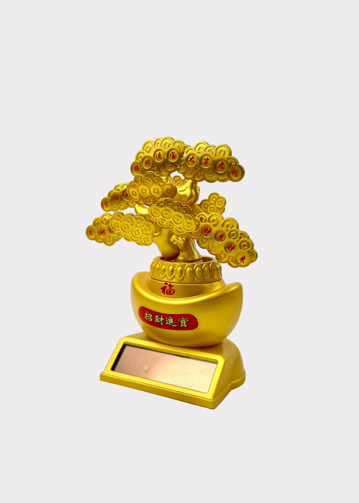 A golden decorative bonsai-style tree figurine with coin-like leaves, mounted on a gold pot and rectangular base, photographed against a plain light background.