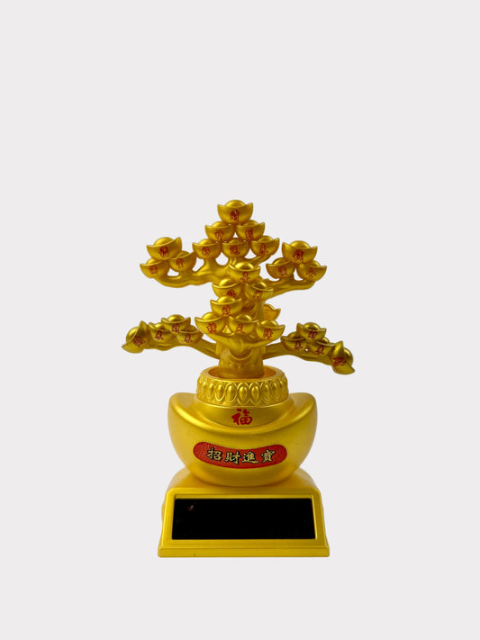 A golden Feng Shui money tree figurine with a gold ingot base, red Chinese characters, and a black solar panel plaque on a white background.