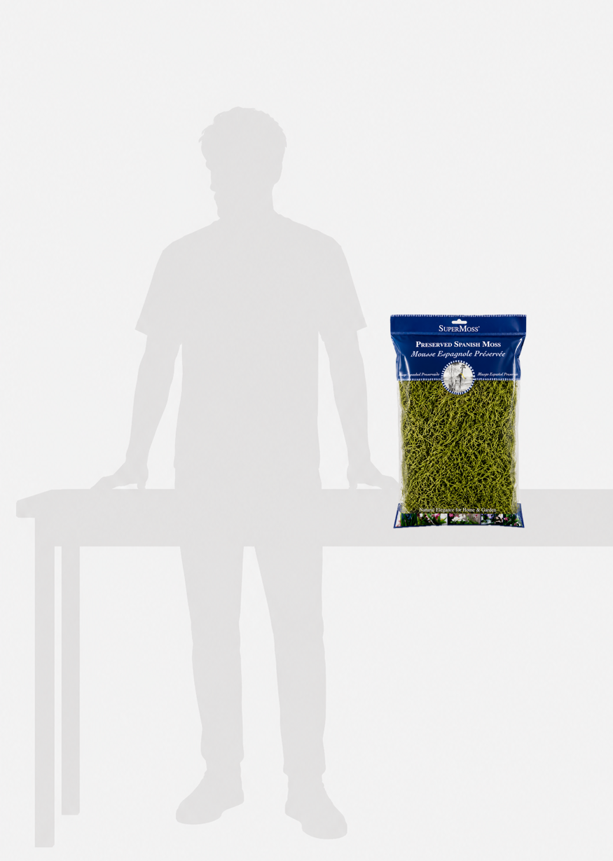 Bag of green pet food on a white table with a silhouette of a person for scale.