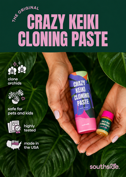 Crazy Keiki Cloning Paste packaging held by hands with green leaves in the background