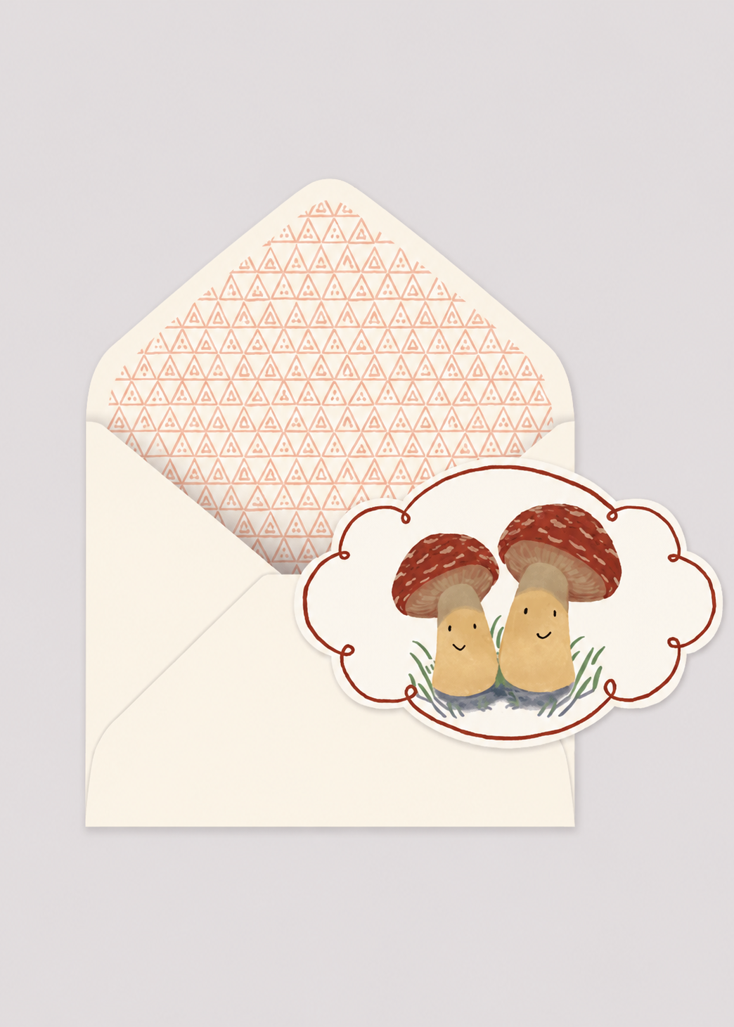 Card with two cartoon mushrooms and an envelope with a geometric pattern on a light gray background