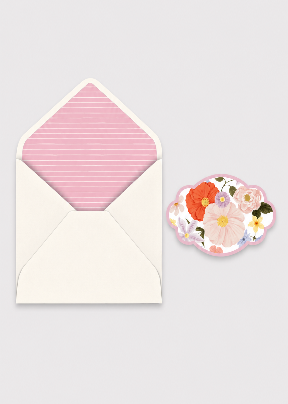 Floral card and pink envelope on a light gray background