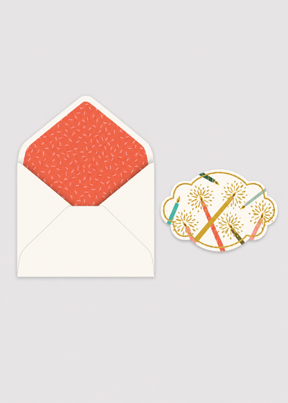 Greeting card with orange patterned envelope and decorative sticker on a gray background