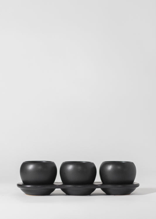 three planters on saucer in black. each planter has a 2" opening