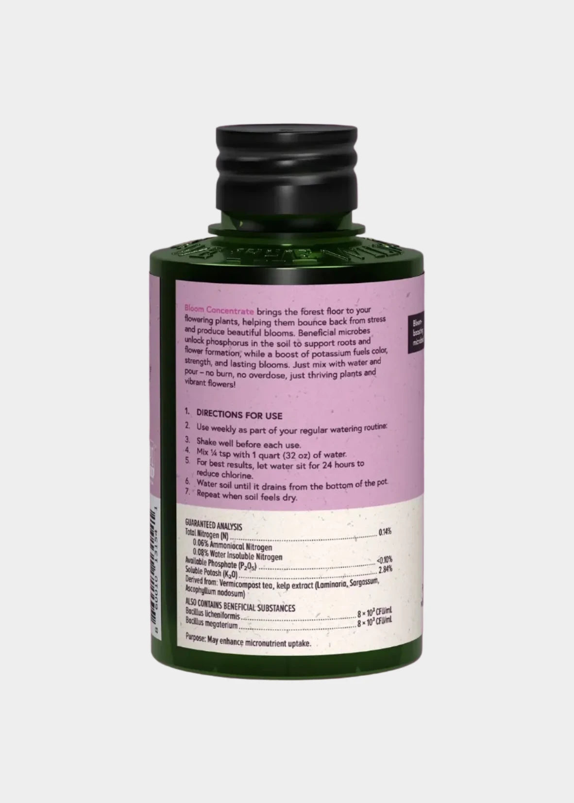 Bottle of plant food with label on a gray background