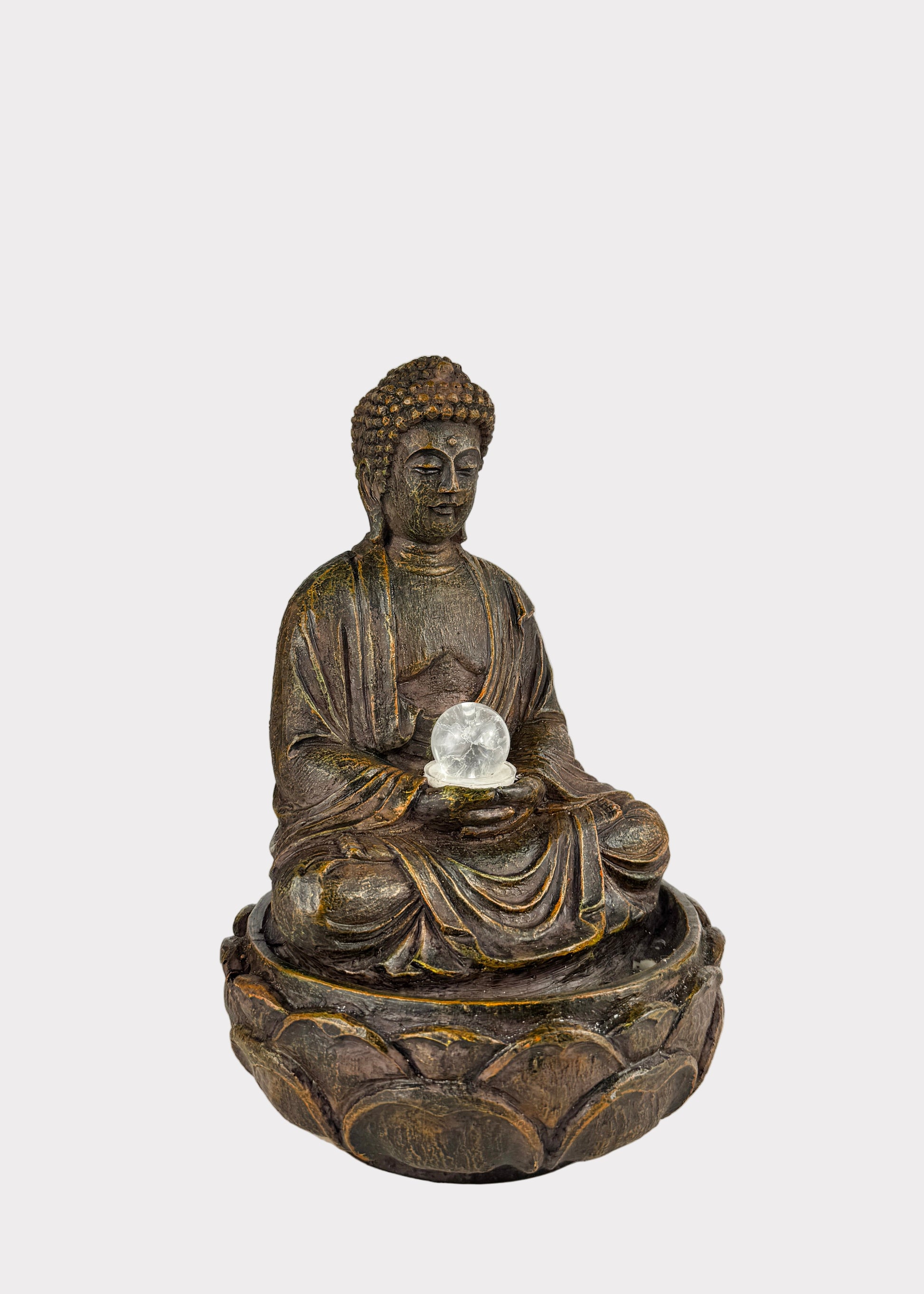 Bronze Buddha statue holding a crystal ball on a white background