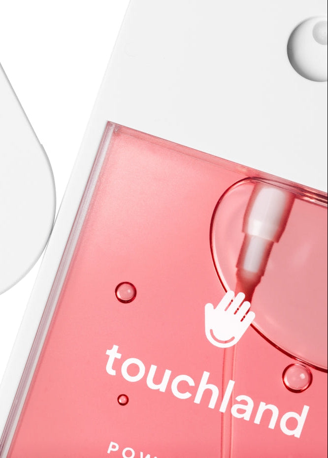 Pink skincare product with 'touchland' branding on a white background