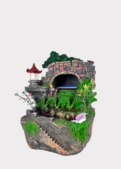 indoor water fountain with pagoda and mountain scene