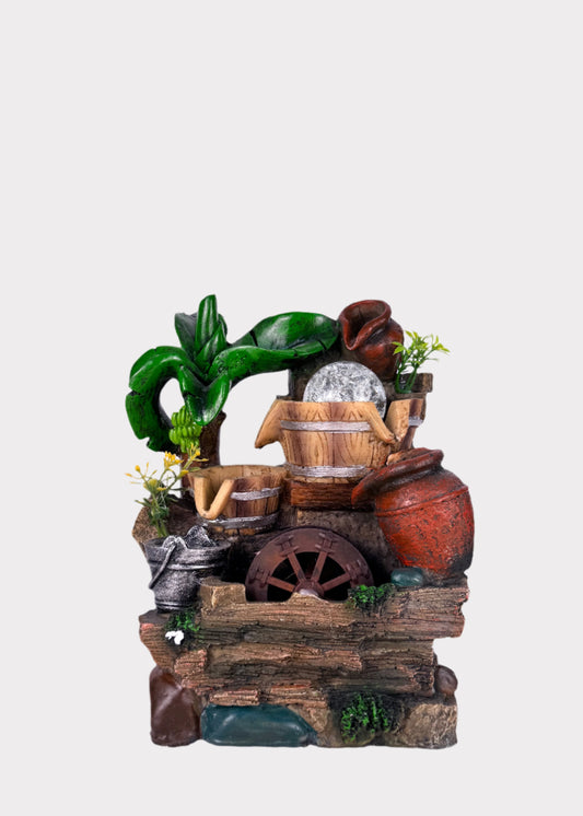 Rustic village water wheel fountain with barrels, pots, greenery, and LED crystal ball - front view - Rainbow Rosemead